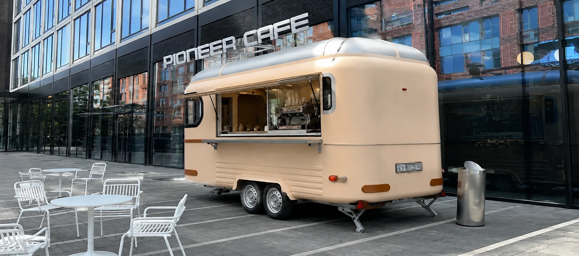 User-supplied concept scene of a cream Kiosk Vista trailer outside a café